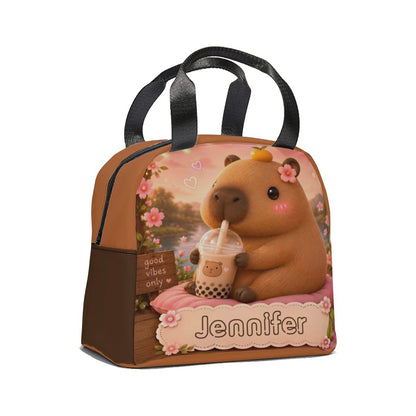 Kids lunch bag with top handle, front-view bear sipping drink, brown floral print, Jennifier.