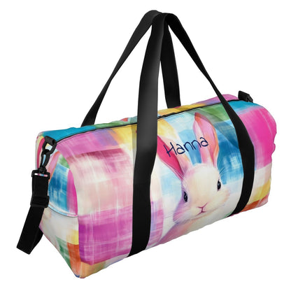 Travel duffel bag with colorful rabbit print, black straps, and top carry handles