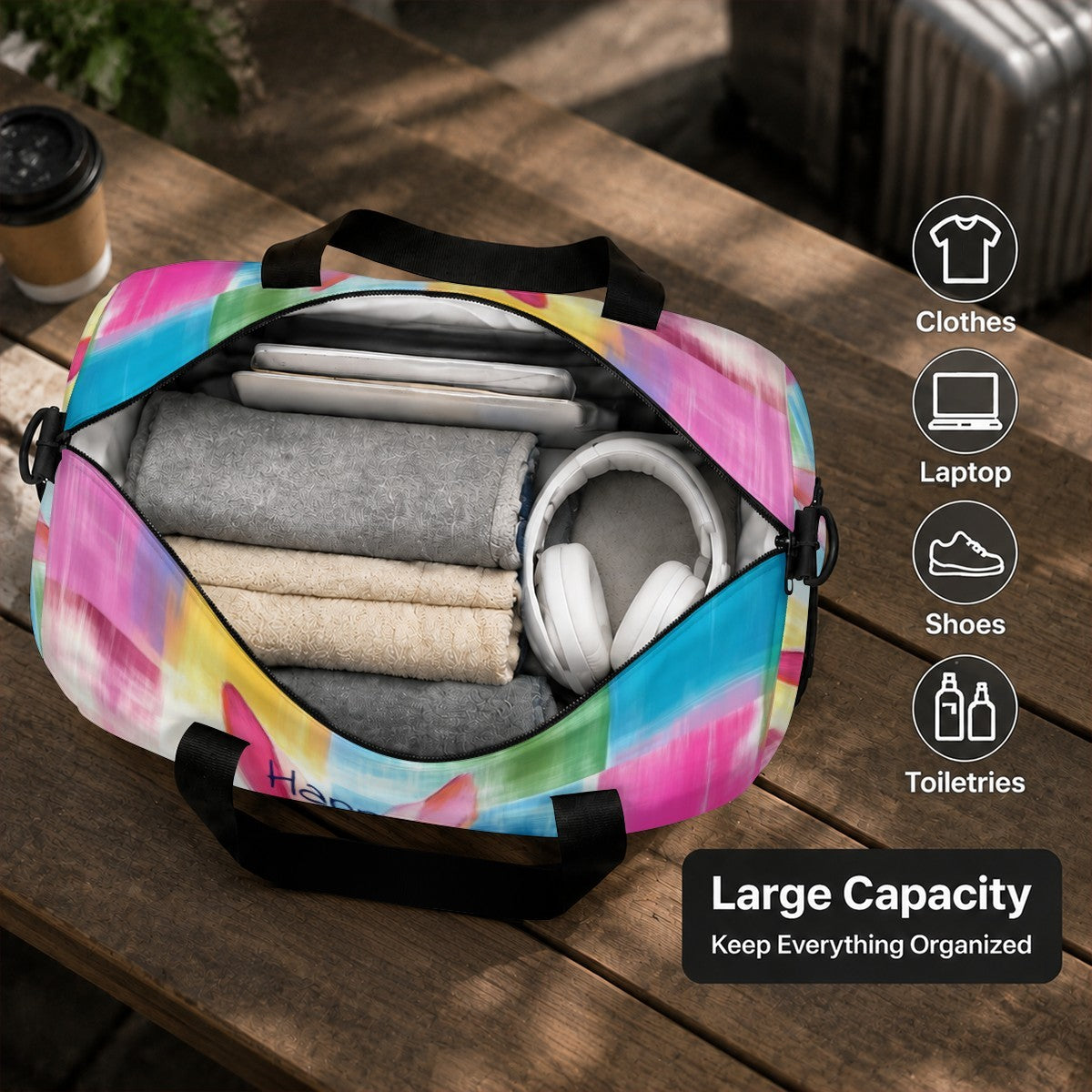 Open duffel bag with colorful rabbit print, showing folded clothes and headphones