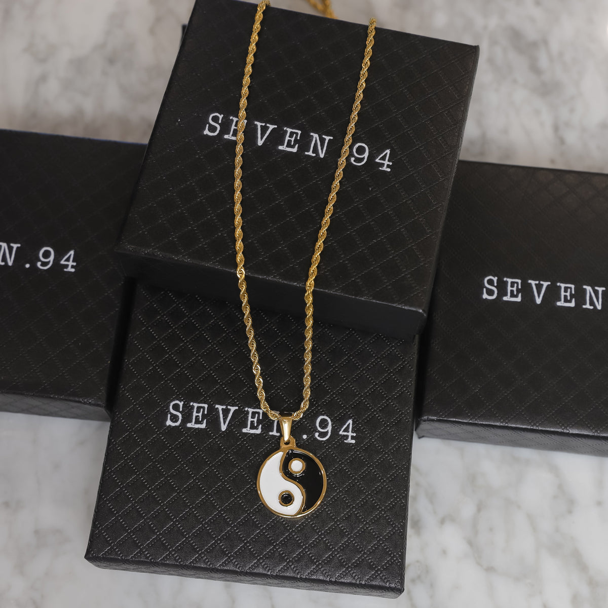 Gold yin yang pendant necklace with small round black and white enamel charm