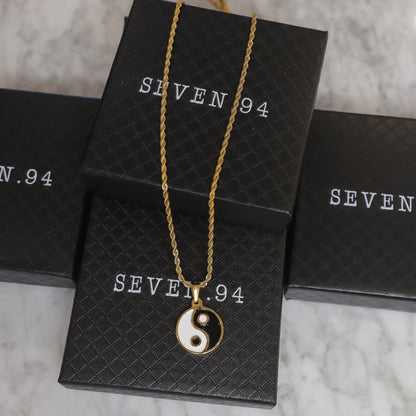 Gold yin yang pendant necklace with small round black and white enamel charm
