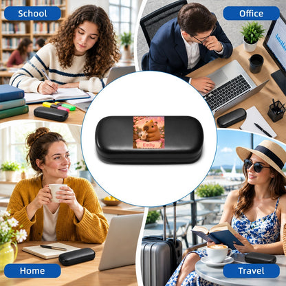 Black eyeglasses case with capybara photo insert, shown in an outdoor lifestyle scene.