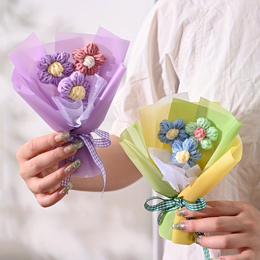 Purple paper bouquet with crocheted flowers and lilac ribbon, held in hands