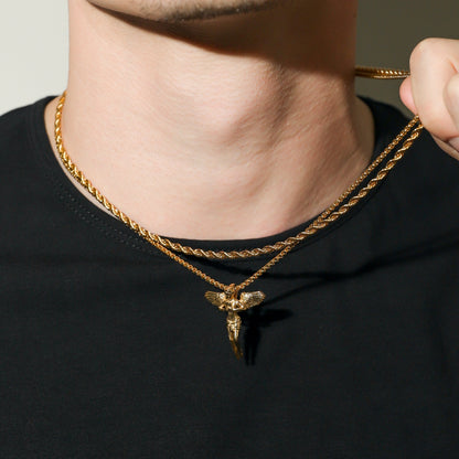Gold rope chain necklace with guardian angel pendant, close-up at the collar