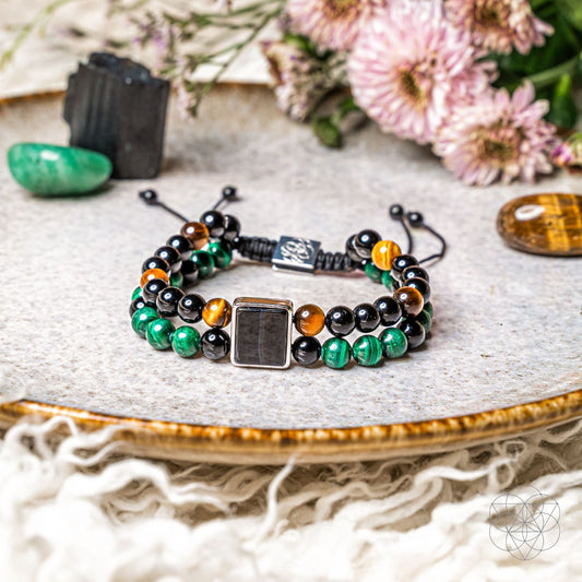 Beaded power bracelet with black and green stones, orange accents, and square clasp