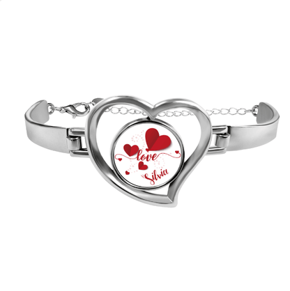 Silver-tone heart locket bracelet with red hearts and cursive name inside