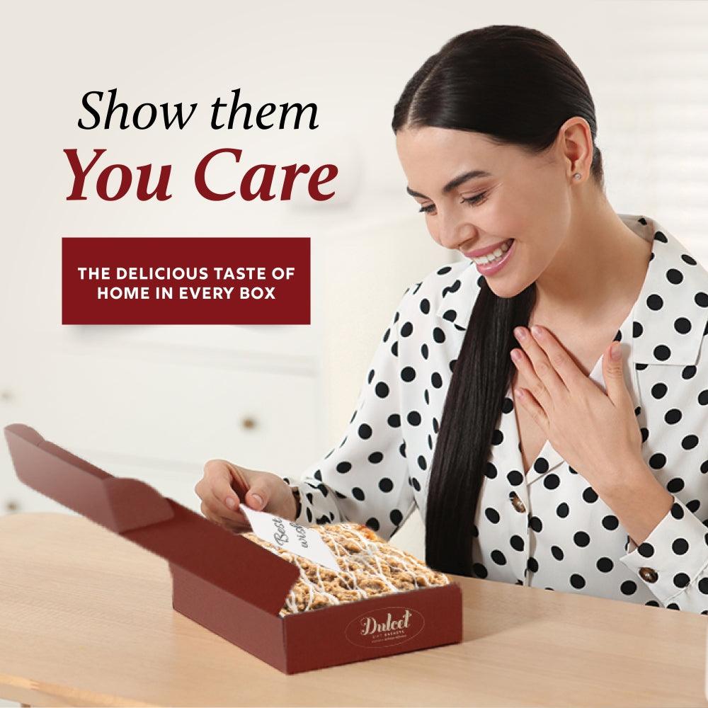 Gift box being opened with cookies inside; showing Dulcet branding on the lid