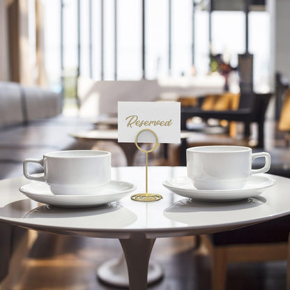 Gold table number holder with circular base displaying a reserved card between cups