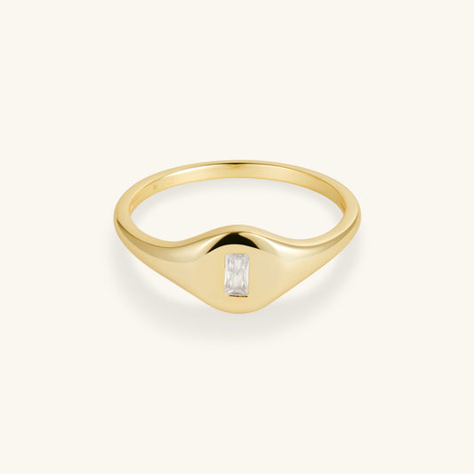 Gold-tone signet ring with baguette-cut crystal set in tapered bezel