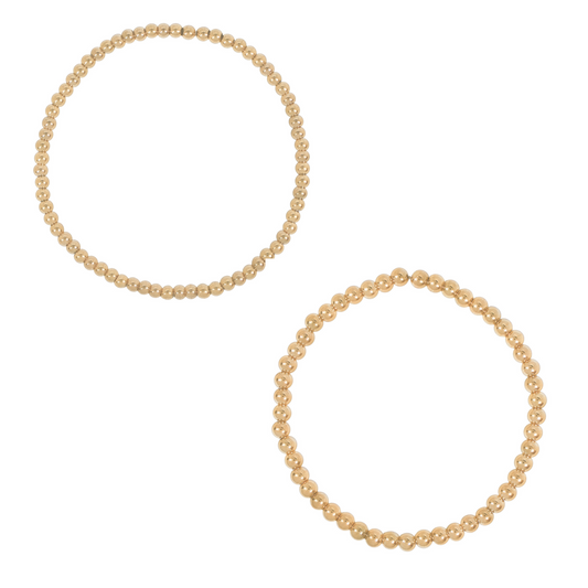 Two gold-tone beaded bracelets, flat lay pair