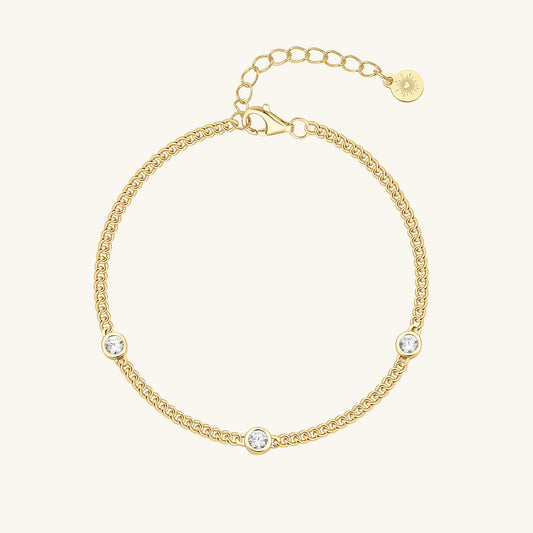 Gold curb chain bracelet with three bezel-set cubic zirconia stones