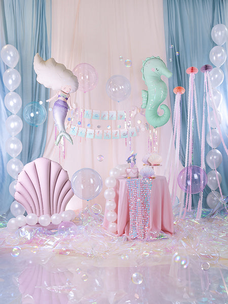 Mint green seahorse helium balloon with star accents, next to round balloons