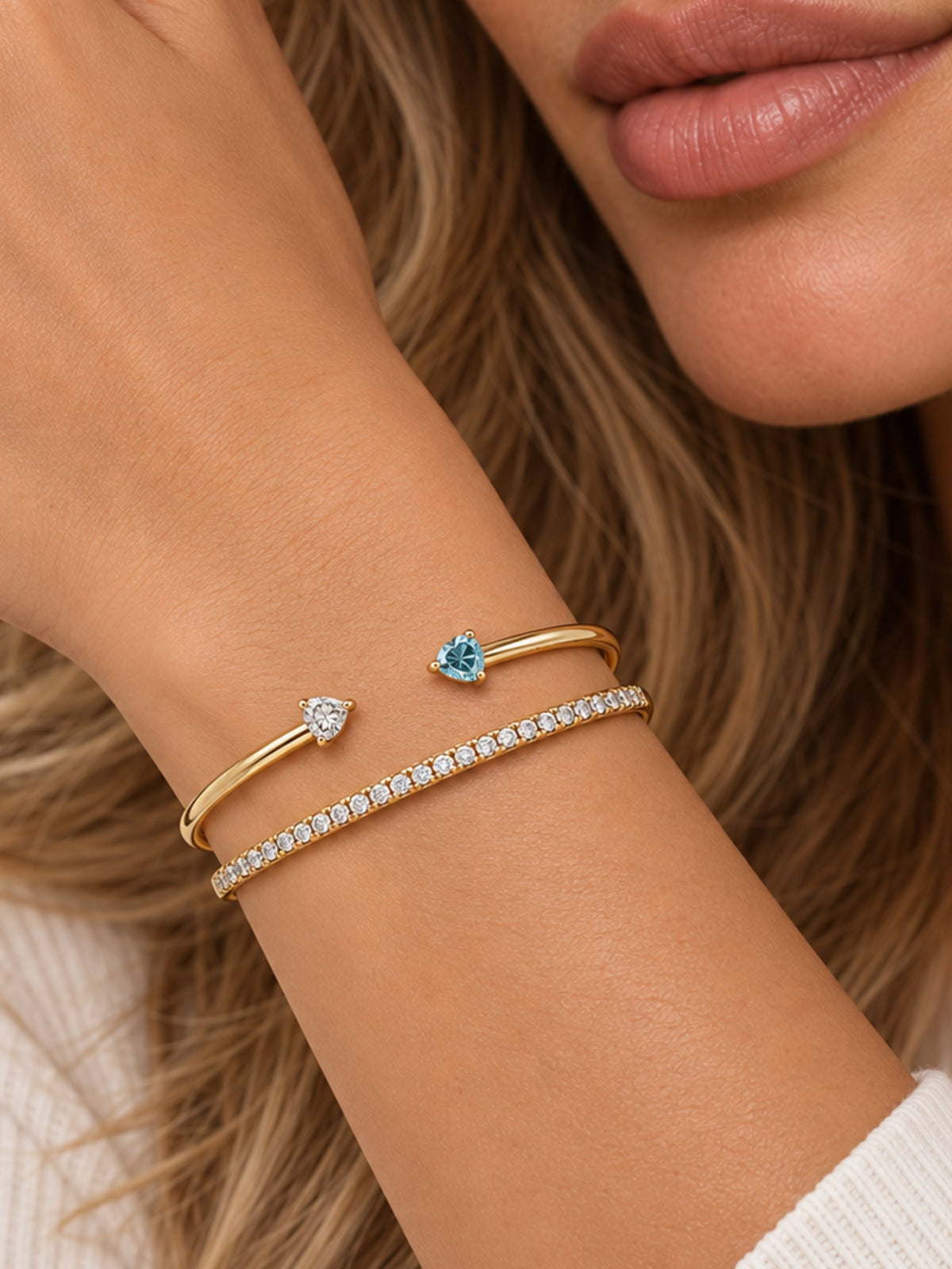 Gold filled thin pave cuff bracelets stacked on wrist, one with clear stones and heart charm