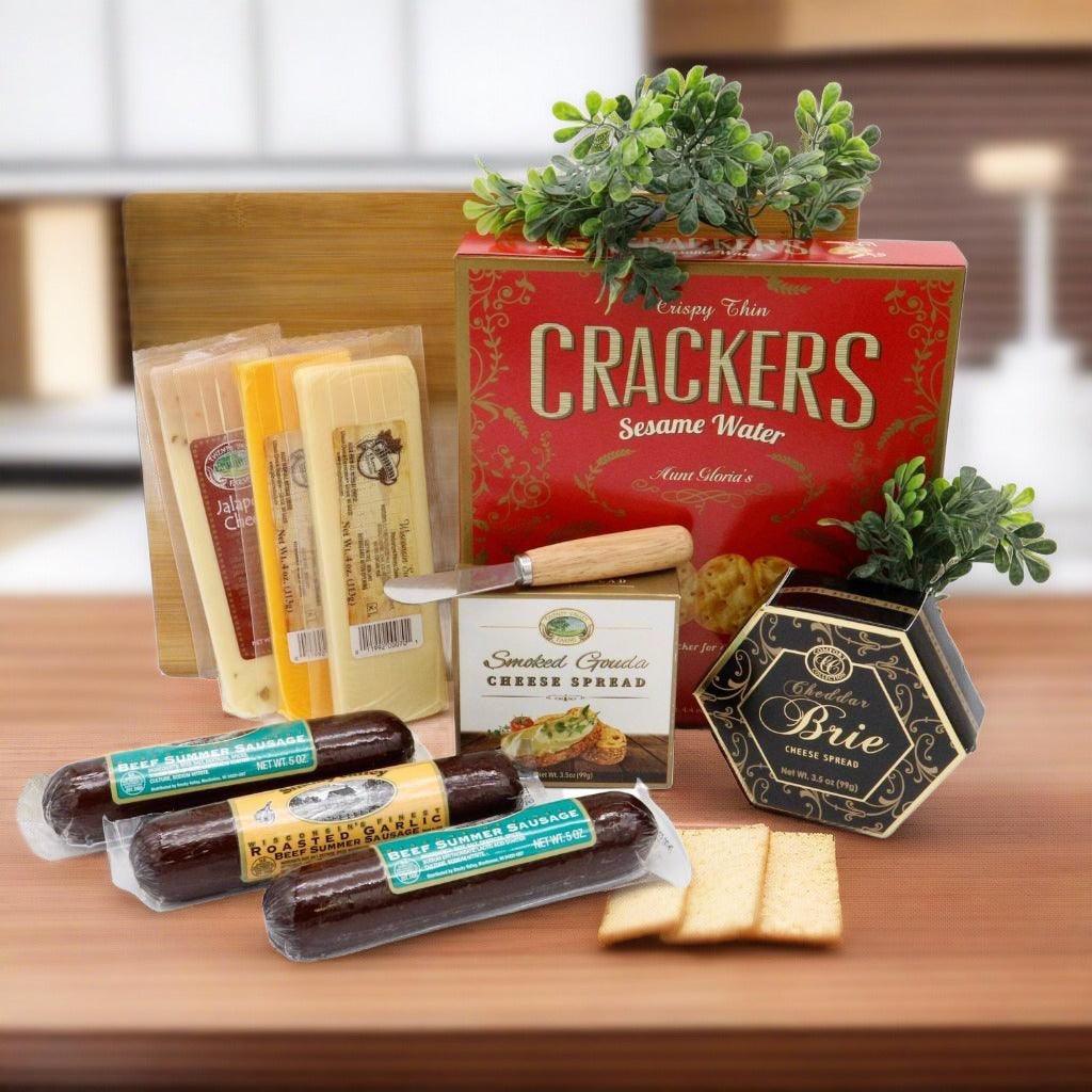 Wooden cutting board with crackers, cheese spread boxes, and sliced cheeses