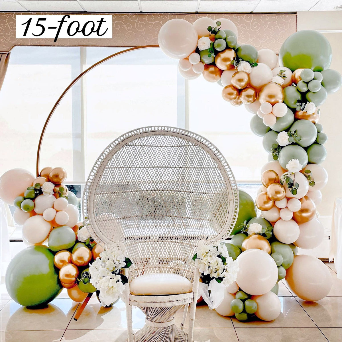Balloon garland arch kit arrangement with sage green, gold and cream balloons and chair