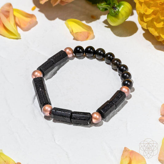 Copper and black bead bracelet with dark rectangular stone-like segments