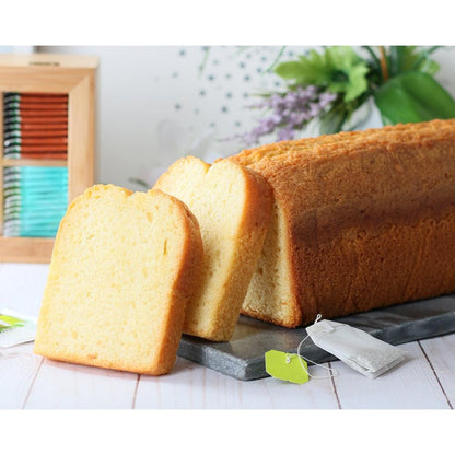 Golden pound cake loaf with two slices beside the loaf