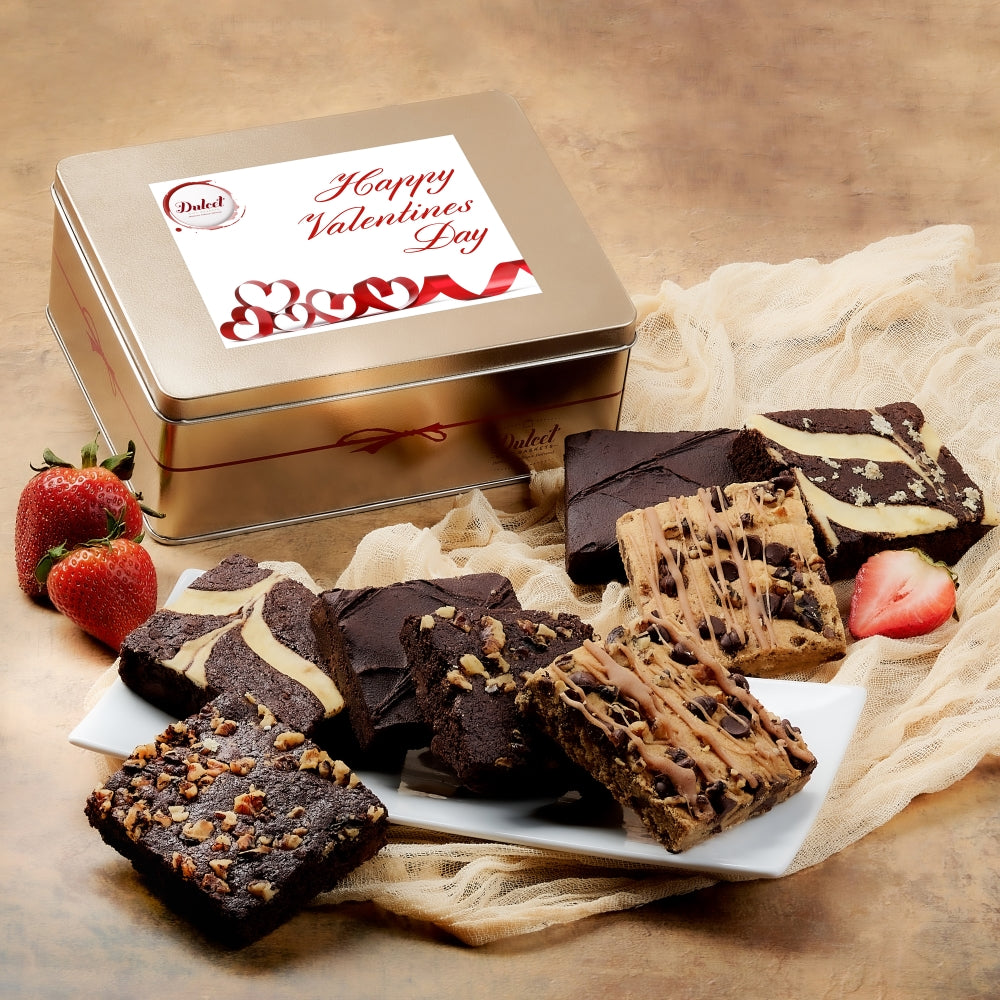 Stacked metal brownie gift box labeled Valentine's with assorted chocolate brownies on paper