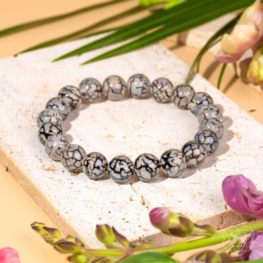 Gray and white river agate bead bracelet with round beads on elastic cord.