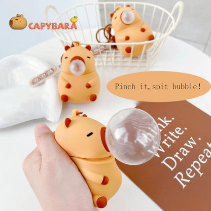 Capybara squeeze plush keychain with clear bubble dome and small clip attachment