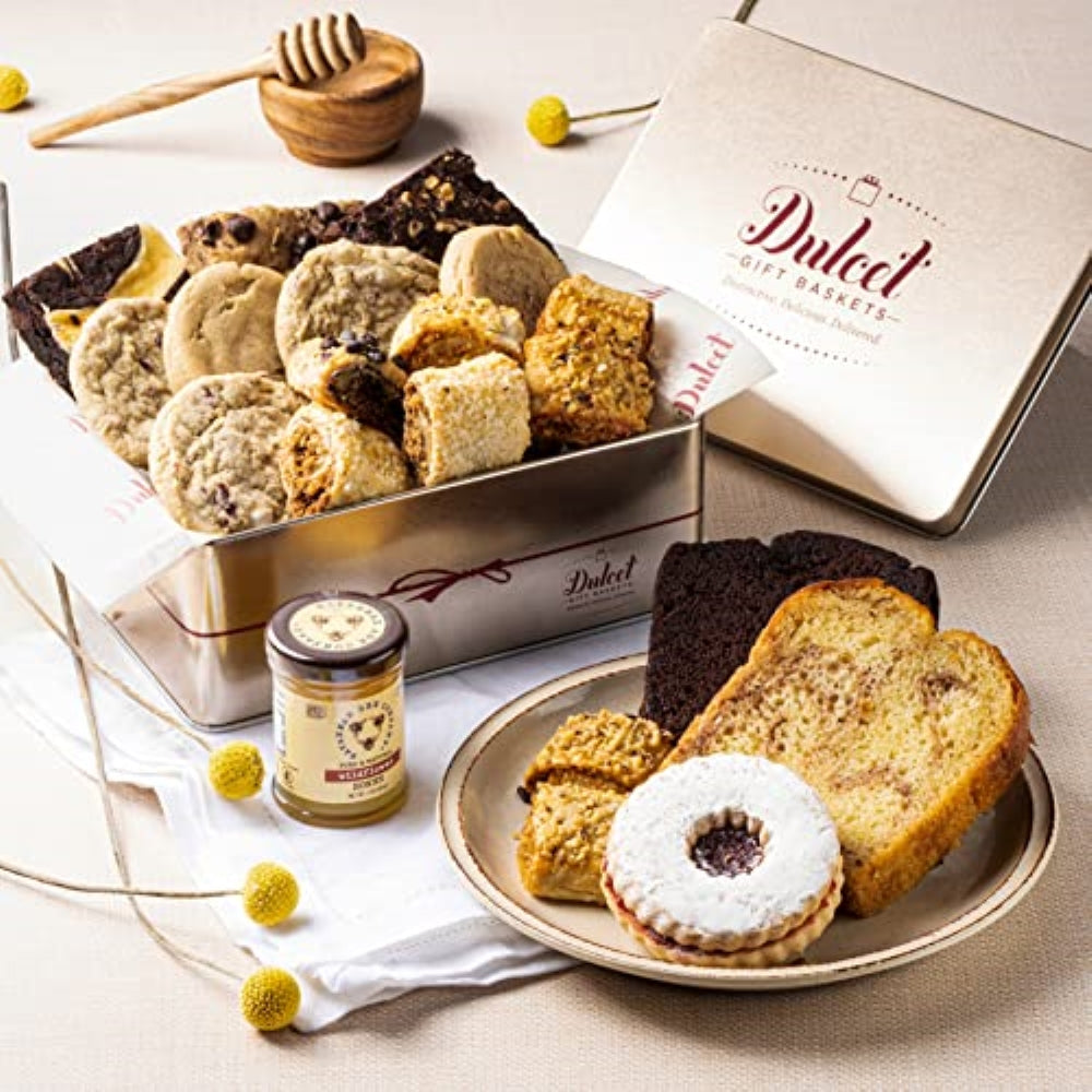 Deluxe honey pastry gift tin with assorted cookies and two cake slices on round platter