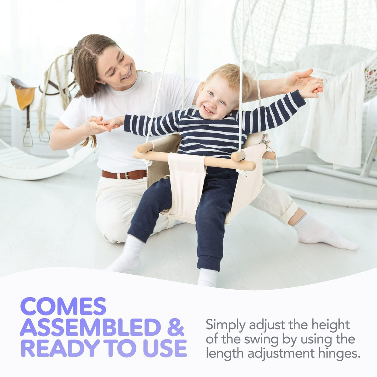 White canvas baby hanging swing with wooden dowels, child and toddler playing