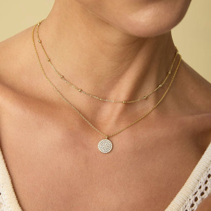 Gold layered necklace with pavé disc pendant