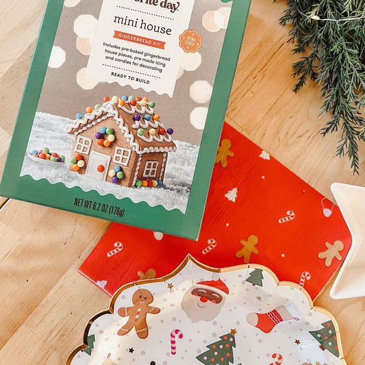 Christmas icon plates with red back and white pattern, shown on wood tabletop near building kit