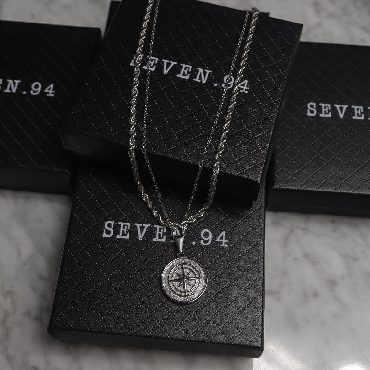 Silver compass pendant necklace set in black gift bags