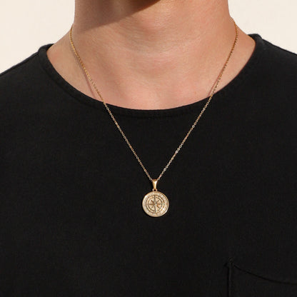 Gold compass pendant necklace on chain with round compass medallion