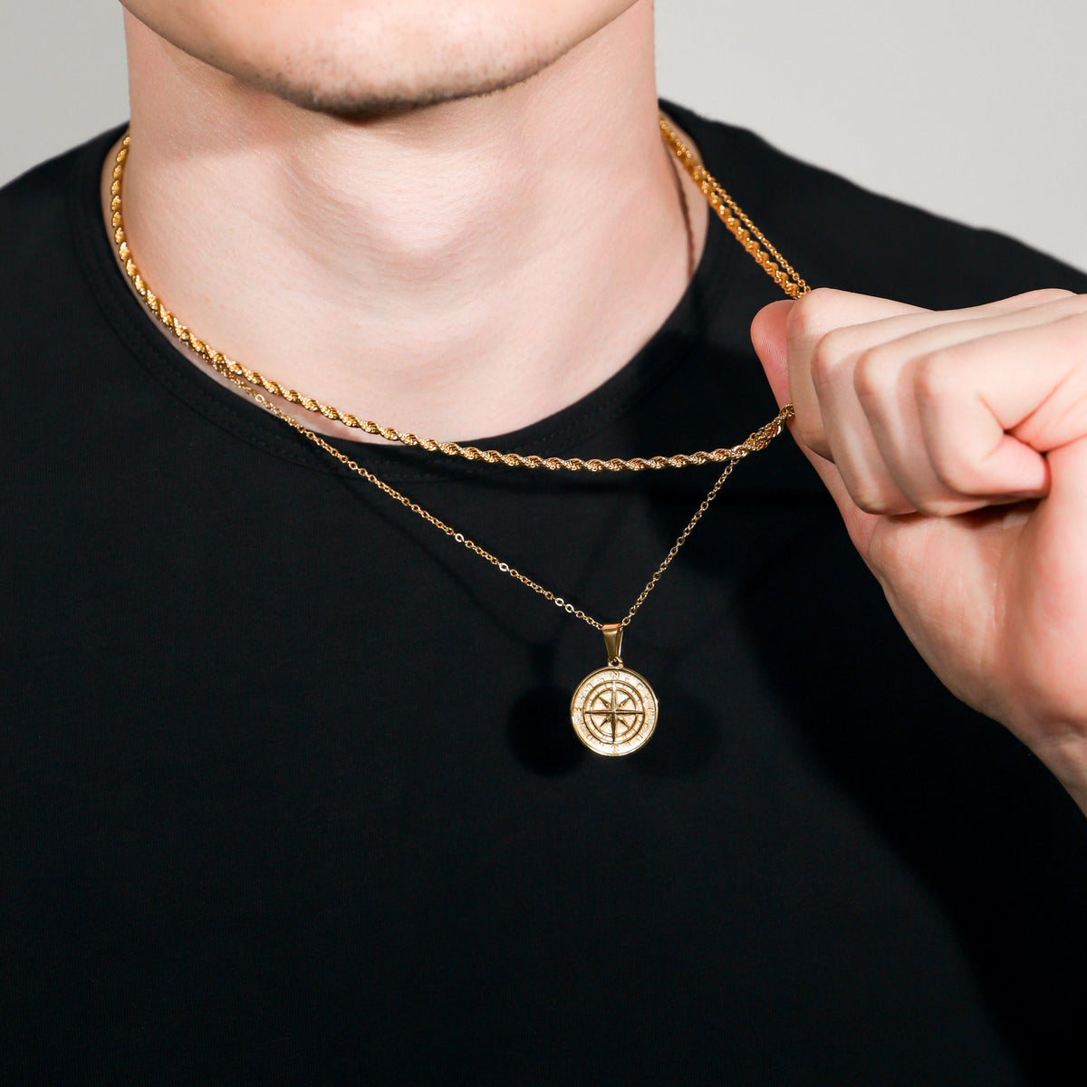 Gold rope necklace set with compass pendant, hand adjusting chain