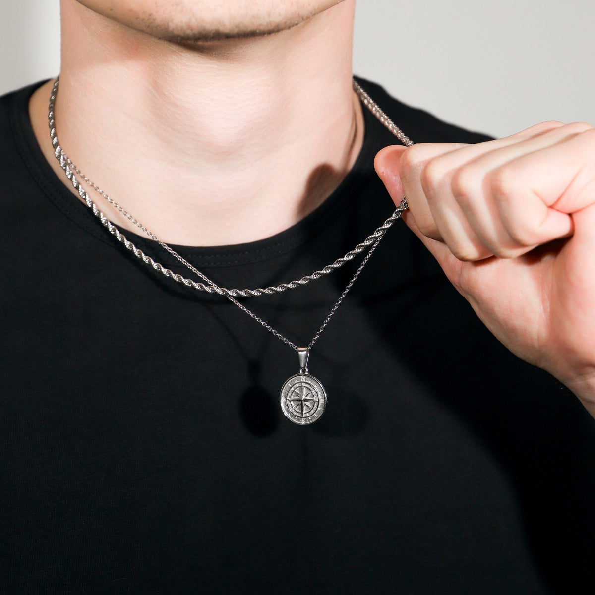 Silver rope necklace set with compass pendant, hand adjusting chain