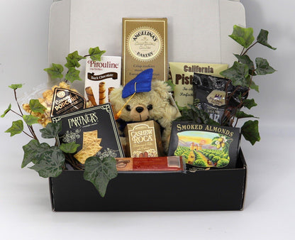 Open graduation gift box with plush teddy and assorted cookies, nuts, and snack bars