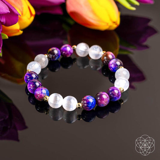 Purple and white beaded bracelet with round beads and small gold spacer beads