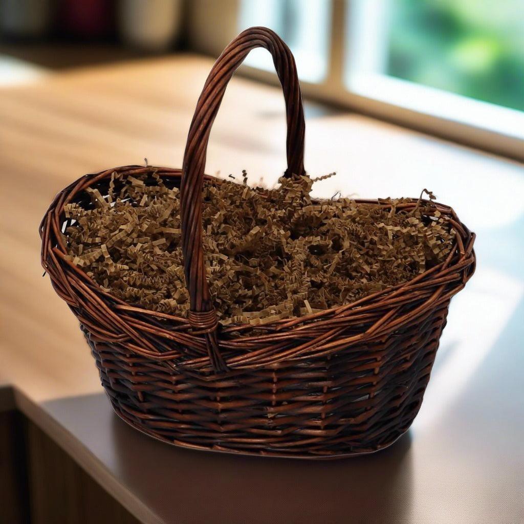 Wicker gift basket with loop handle and brown paper filler