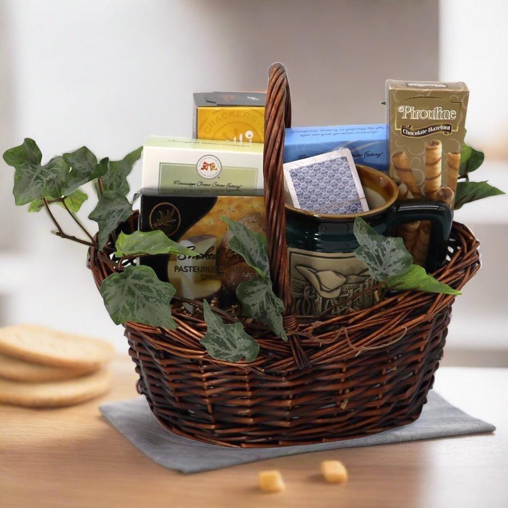 Wicker gift basket with assorted cheese, crackers, chocolate hazelnut snacks, and decorative filler