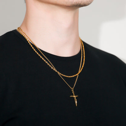 Gold crucifix pendant necklace with layered rope chain and cross pendant
