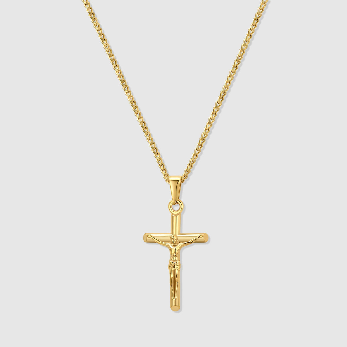 Gold crucifix pendant necklace with curb chain and circular jump ring