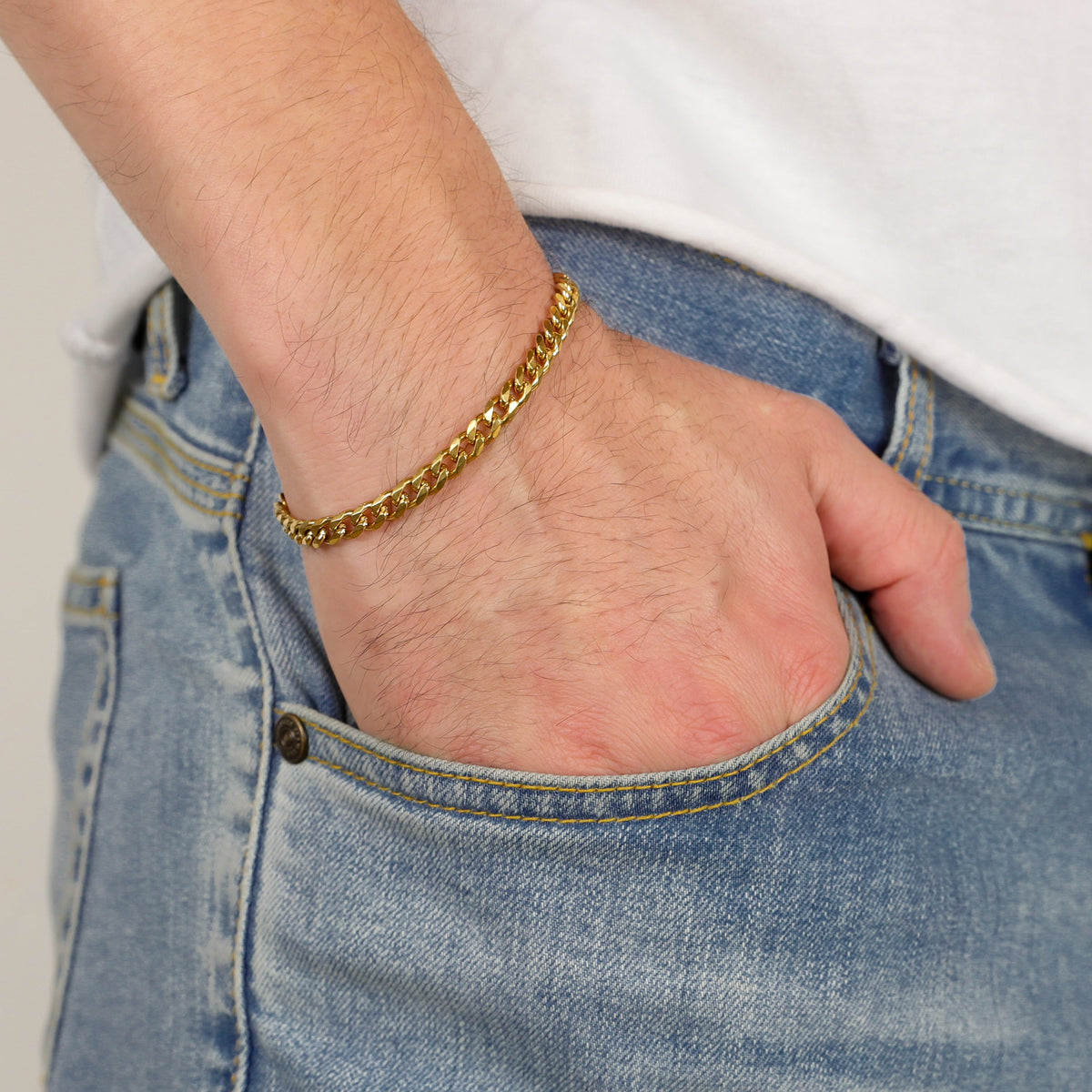 Gold Cuban link bracelet on wrist
