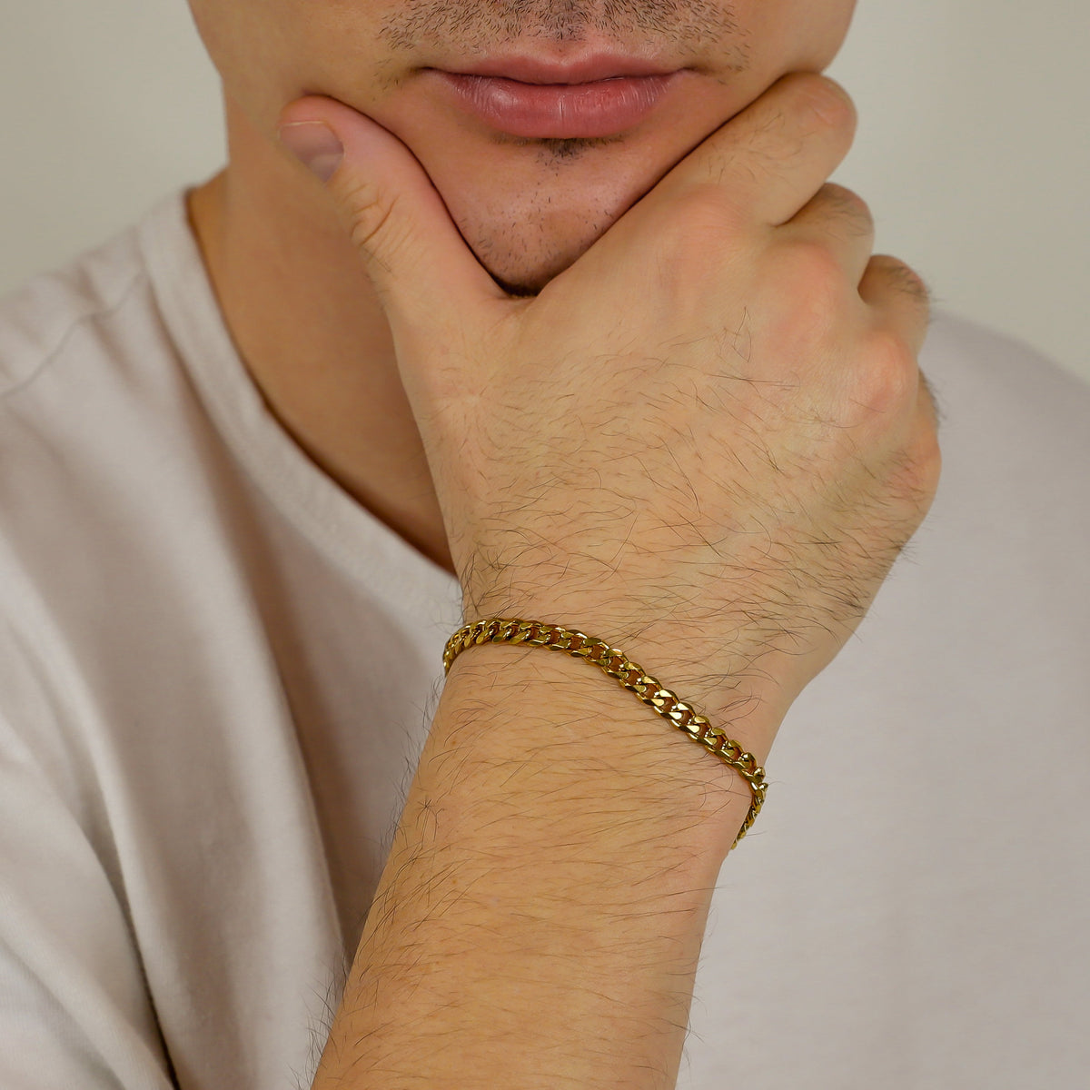 Gold Cuban link bracelet on wrist with clasp visible