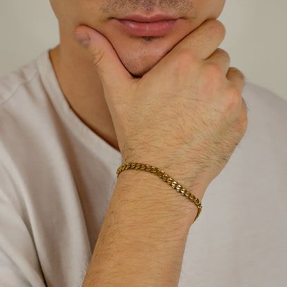 Gold Cuban link bracelet on wrist with clasp visible
