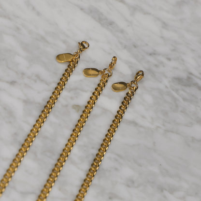 Set of gold Cuban link bracelet chains with clasp ends