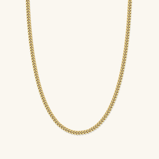 Gold Cuban link chain necklace with small links, V-shaped drape