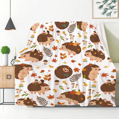 Hedgehog and autumn leaf blanket with white background and brown animal faces, folded