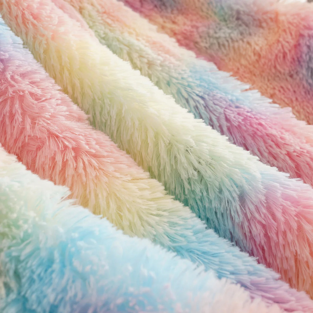 Pastel rainbow fuzzy blanket close-up with multicolor stripe pattern and plush texture
