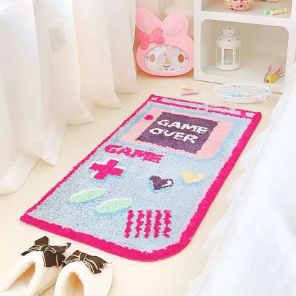 Rectangular game-themed area rug with “Game Over” pixel graphic, pink and light blue border