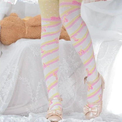 Knee-high socks with pastel rainbow stripes and small printed motifs