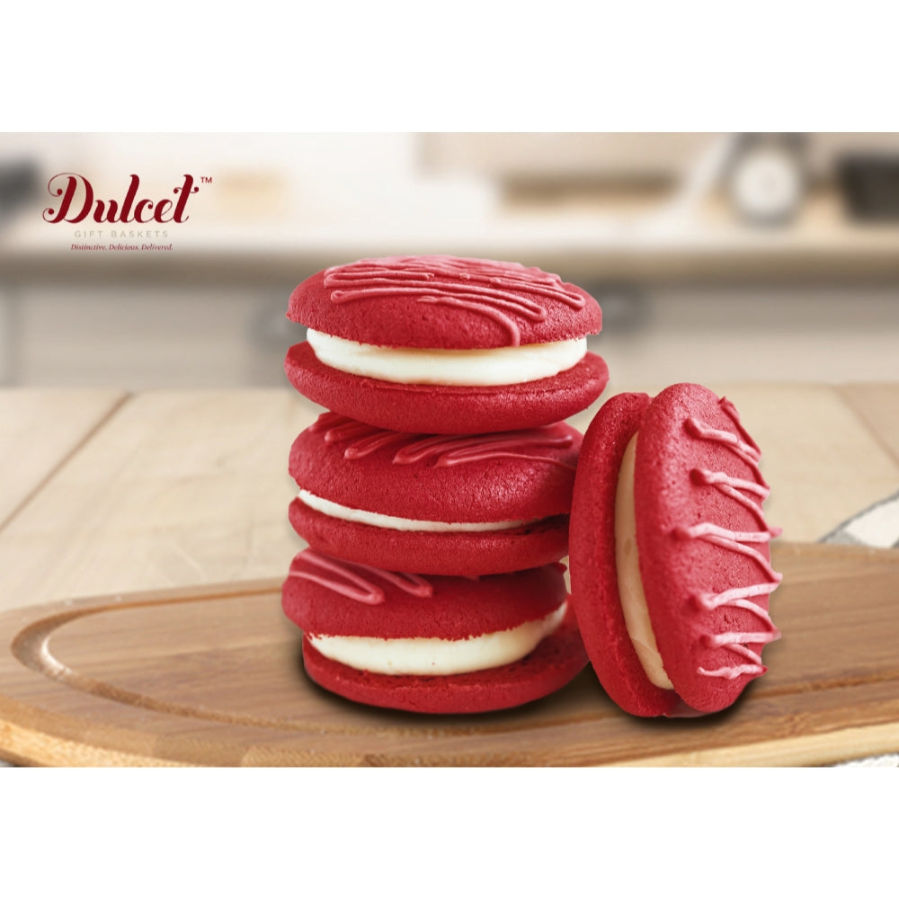 Stack of red macarons with white filling and one halved cookie