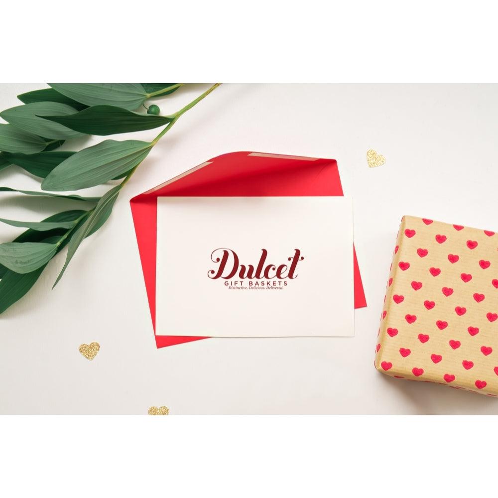 Red-and-white gift box with Dulcet logo next to heart-patterned wrapped package