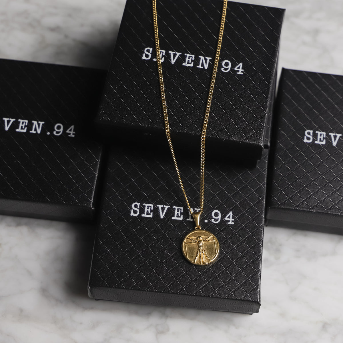 Necklace set in gift boxes with gold-tone chain and circular medallion pendant